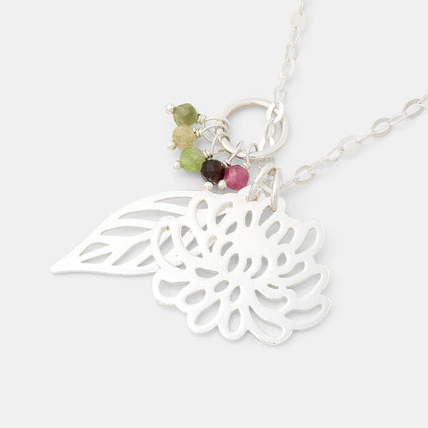 Chrysanthemum and leaf cluster pendant with tourmaline gemstones by Australian jeweller Simone Walsh.