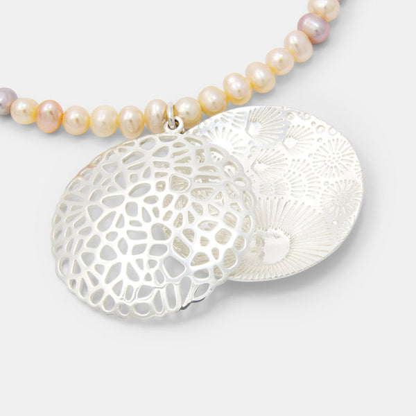 Coral reef open locket on peach pearl necklace