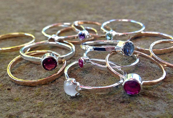 Sterling silver and gold filled stacking rings with gemstone settings.